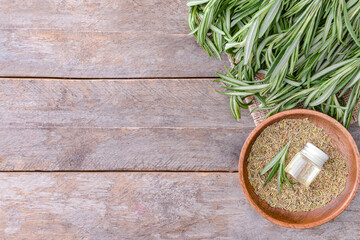 Bottle of rosemary essential oil on table