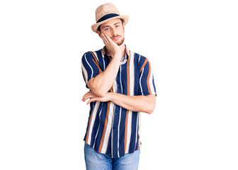 Fototapeta premium Young handsome caucasian man wearing summer hat thinking looking tired and bored with depression problems with crossed arms.