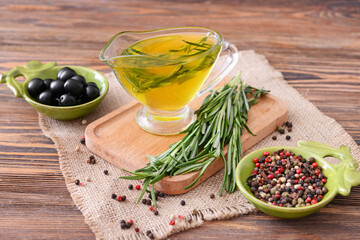 Gravy boat of rosemary oil and spices on table