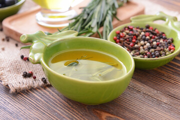 Bowl of rosemary oil and spices on table