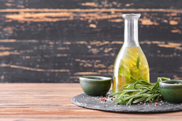 Bottle of rosemary oil and spices on table