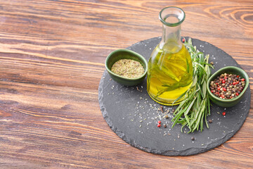 Bottle of rosemary oil and spices on table