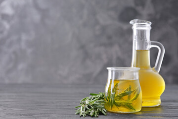 Bottle and jar of rosemary oil on table