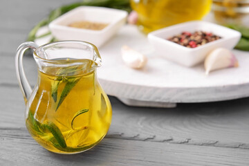 Jug of rosemary oil on table