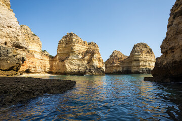 Landscape with cliffs, rock formations and grottoes shaped by the sea at Ponta da Piedade in Lagos, Portugal
