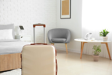 Suitcase in modern hotel room