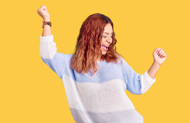 Young latin woman wearing casual clothes dancing happy and cheerful, smiling moving casual and confident listening to music