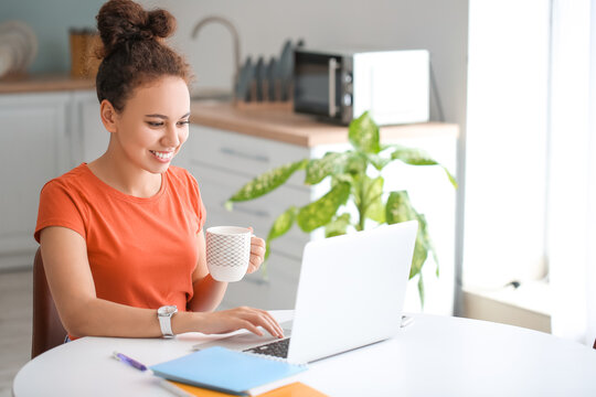 Young woman using laptop for online learning at home