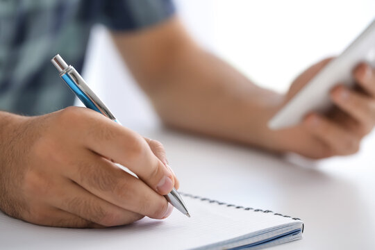 Young man learning at home, closeup