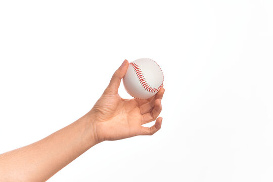 Hand of caucasian young man holding baseball ball over isolated white background
