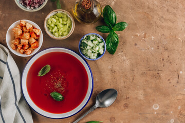 Spanish summer cold soup gazpacho with vegetables on beige rustic background.
