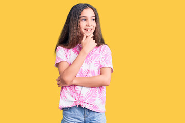 Cute hispanic child girl wearing casual clothes with hand on chin thinking about question, pensive expression. smiling with thoughtful face. doubt concept.