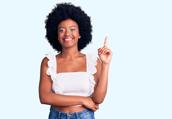 Young african american woman wearing casual clothes with a big smile on face, pointing with hand...