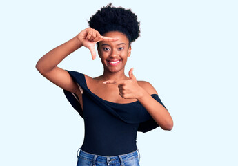 Young african american woman wearing casual clothes smiling making frame with hands and fingers with happy face. creativity and photography concept.
