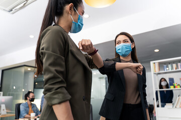 People in office company have elbow greeting during covid pandemic