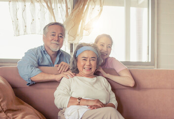 Asian family sitting in living room, Senior father mother and middle aged daughter, Happiness family concepts