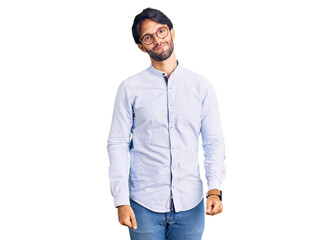 Fototapeta premium Handsome hispanic man wearing business shirt and glasses looking sleepy and tired, exhausted for fatigue and hangover, lazy eyes in the morning.