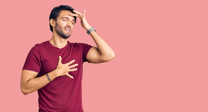 Handsome hispanic man wearing casual clothes touching forehead for illness and fever, flu and cold, virus sick