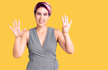 Young beautiful woman with pink hair wearing casual clothes showing and pointing up with fingers number nine while smiling confident and happy.