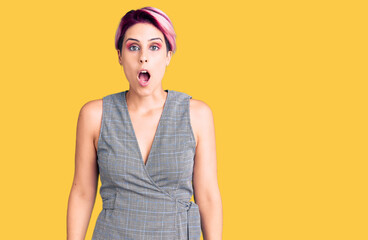 Obraz premium Young beautiful woman with pink hair wearing casual clothes afraid and shocked with surprise and amazed expression, fear and excited face.