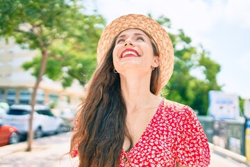 Young blonde woman on vacation smiling happy walking at street of city