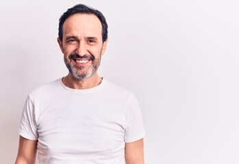 Middle age handsome man wearing casual t-shirt standing over isolated white background with a happy...