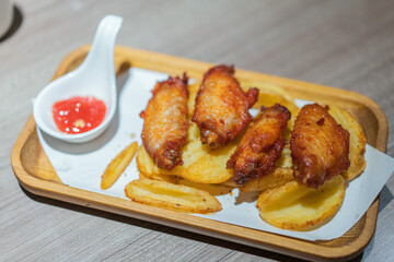 Grilled chicken wings in a wooden tray