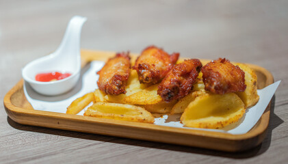 Grilled chicken wings in a wooden tray