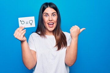 Beautiful woman asking for sex discrimination holding paper with gender equality concept pointing...