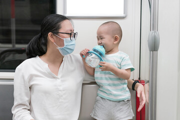 Asian mothers take their children on the subway