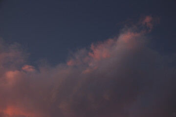 Fototapeta na wymiar A huge pink cloud shot at dusk.