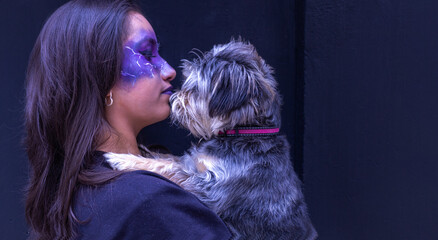 Teenage girl in Halloween makeup with her dog