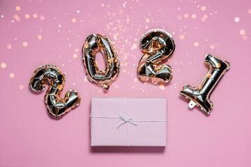 2021 golden foil numbers with bokeh and present. Top horizontal view flatlay copyspace.