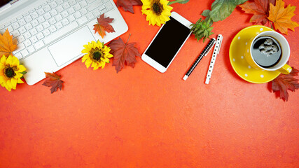 Autumn Fall Halloween Thanksgiving theme desktop workspace with laptop on stylish orange textured background. Top view blog hero header creative composition flat lay.