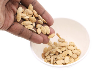 Heap of pumpkin seeds or Diyafa seeds isolated on white background