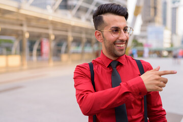 Young handsome Persian businessman exploring the city