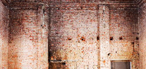Old building falling apart with broken windows, walls covered with cracks and scratches
