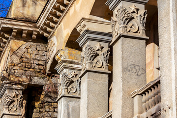 Old building falling apart with broken windows, walls covered with cracks and scratches
