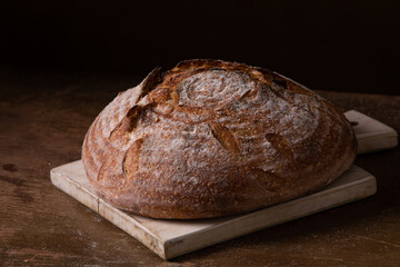 Freshly baked sourdough bread with floral decoration on it 