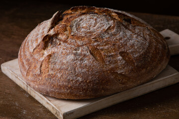 Freshly baked sourdough bread with floral decoration on it 
