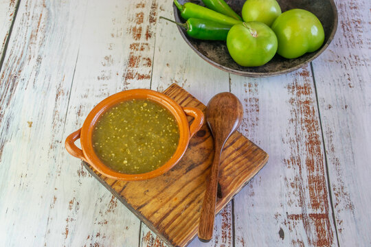 Mexican green sauce with tortilla chips, tomatillos and serrano pepper