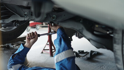 Mechanic auto mechanic in uniform repairing.car in auto machine tools ready to be used with car service.selective focus.