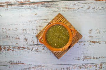 top view of mexican green sauce in clay pot