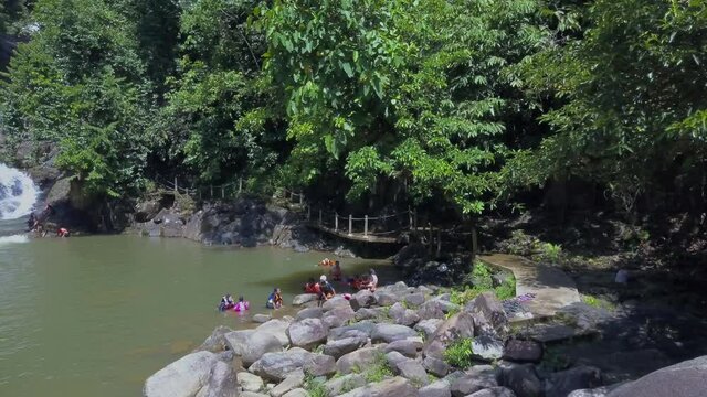 Kenyir, Malaysia - July 23, 2020: Rotating aerial view of Lasir waterfall or Air terjun Lasir, tourist attraction in Terengganu.