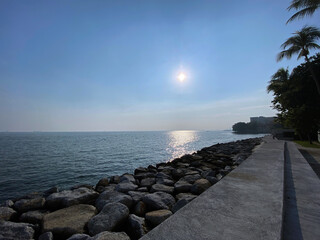 Fototapeta na wymiar morning sunrise sea blue sky calm wave rocky shore Penang Malaysia