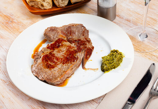 Prepared steak of beef with pesto sauce at plate. High quality photo