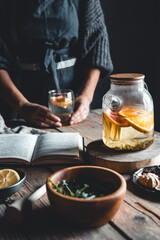 Woman cooks in a vintage kitchen on wooden tablet. Healthy drink, Eco, vegan.