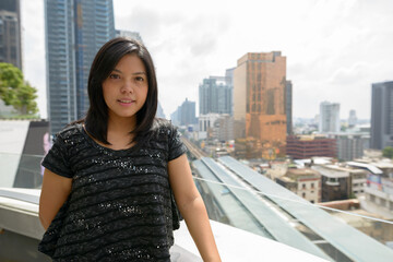 Portrait of Asian businesswoman against view of the city