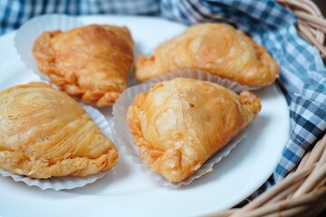 Obraz na płótnie Canvas Thai curry puff pastry stuffed with chicken inside