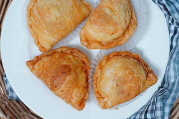 Thai curry puff pastry stuffed with chicken inside